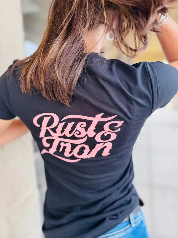 Navy blue woman’s staple tee featuring pink Rust & Iron text on the back