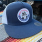 Navy blue and white Bull Truckee mesh hat with circular logo patch for first responders