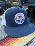 Navy blue and white Bull Truckee mesh hat with circular logo patch for first responders