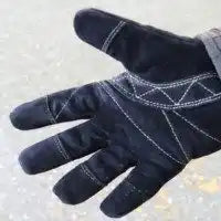 Navy blue work glove with white stitching pattern.