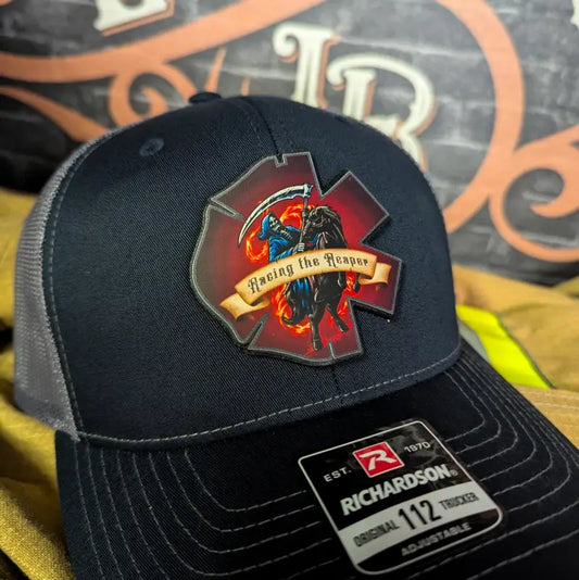 Navy and gray trucker hat featuring EMS Reaper leather patch for first responders