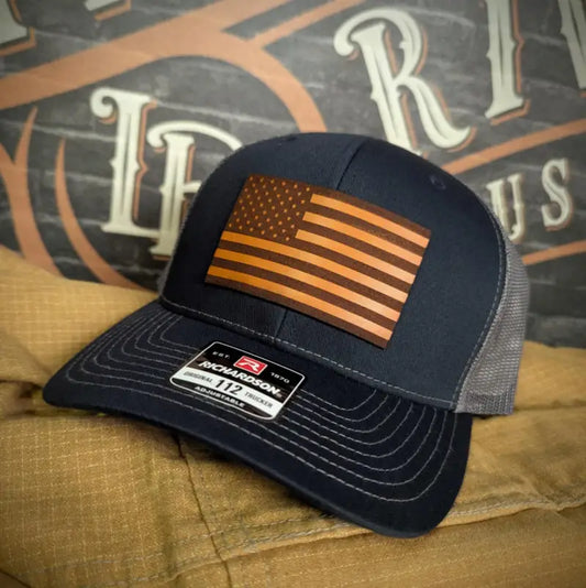 Navy and gray trucker hat with American flag patch and leather patch for various head sizes