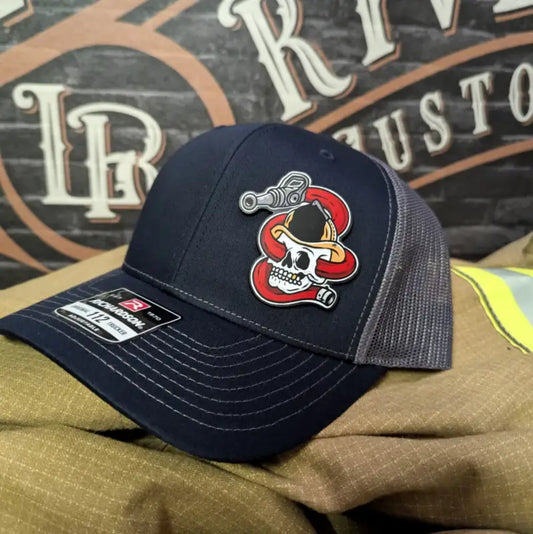 Navy and gray trucker hat with firefighter skull patch for first responders and police
