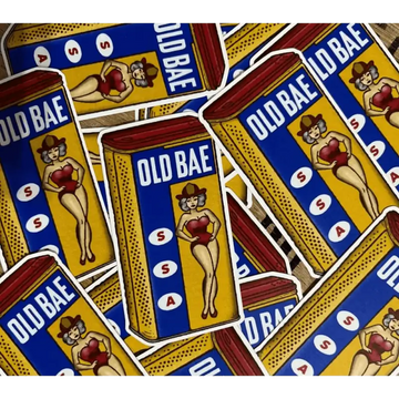 Multiple Old Bae seasoning containers featuring retro pin-up artwork on blue and gold packaging
