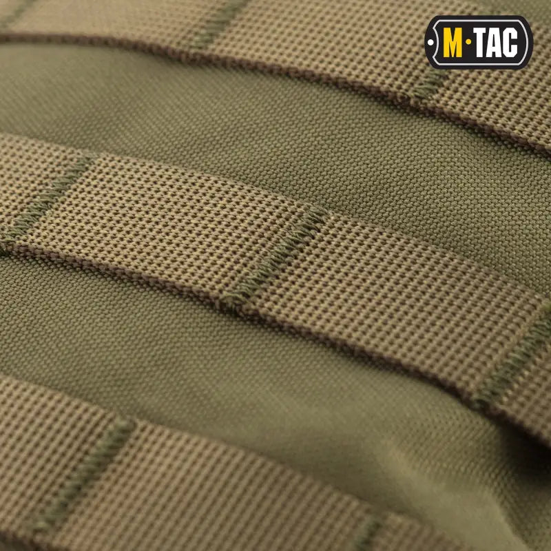 Olive-colored tactical MOLLE webbing on M-Tac Assault Pack with large main zippered compartments