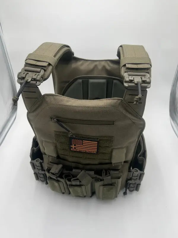 Olive drab tactical plate carrier with modular attachments for large size body armor by Redemption Tactical