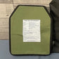 Olive green ballistic plate with black border from Crusader 2.0 body armor set with medical kit