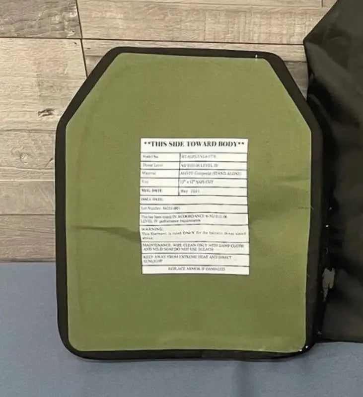 Olive green ballistic plate with black border from Crusader 2.0 body armor set with medical kit