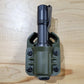Olive-green MCH Duty Flashlight Carrier with black flashlight for duty flashlight use