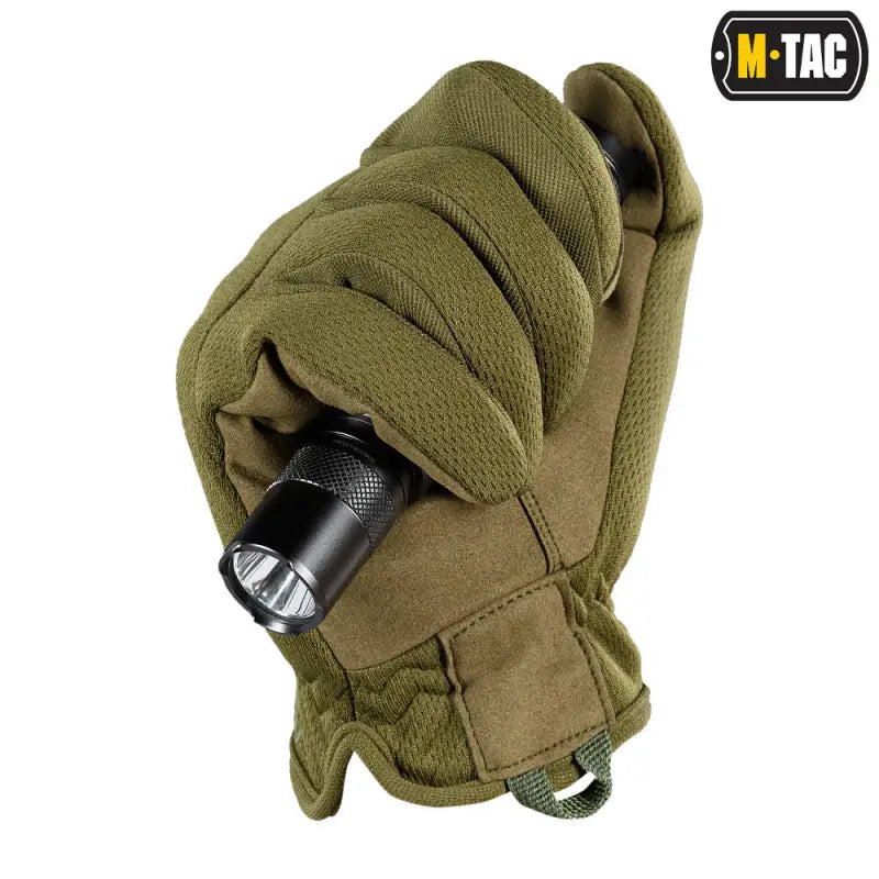 Olive green M-Tac Gloves Scout Tactical Mk.2 holding a black flashlight, synthetic leather gloves