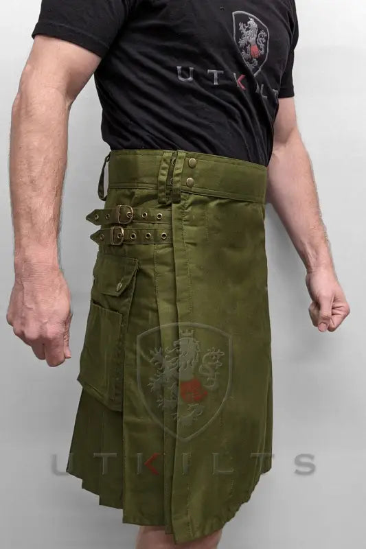 Olive green utility kilt featuring buckle straps and pleats for a rugged look