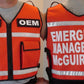 Orange emergency response reflective vest with CEX OEM and EMERGENCY MANAGEMENT McGUIRE AFB