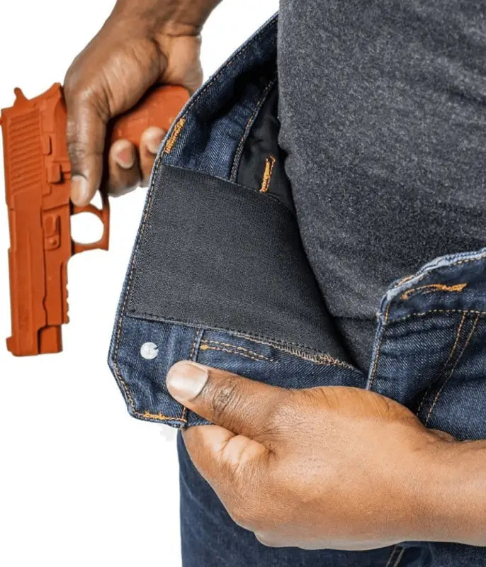 Orange training pistol drawn from Asset Tactical Jeans for optimal accessibility