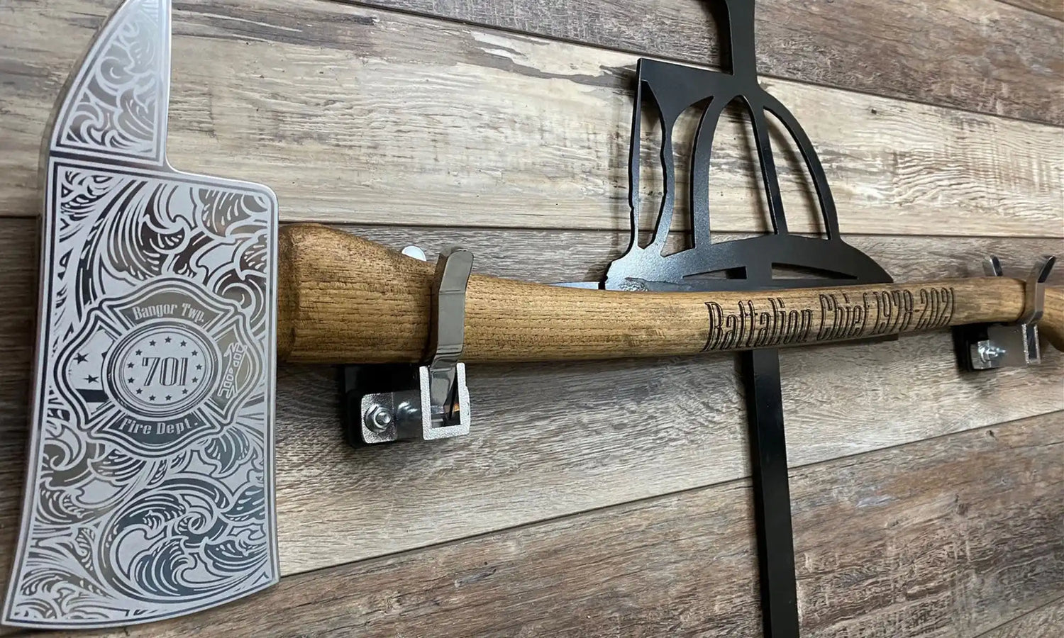 Ornate axe with an engraved metal head and wooden handle.