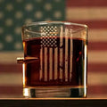 Patriotic Rocks Glass featuring etched American flag with dark beverage and bullet
