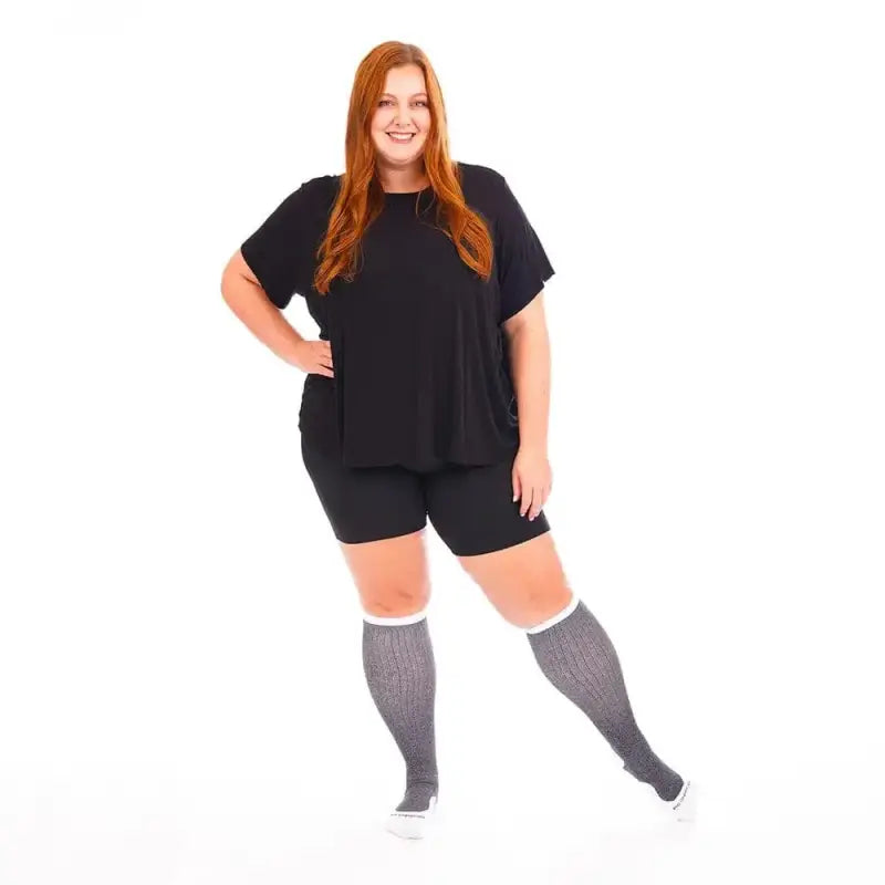 Person in black t-shirt and shorts wearing Marathon Wide-Calf Heather Slate knee-high socks