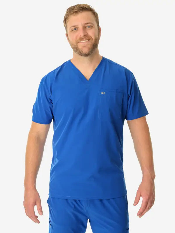 Person in bright blue men’s double-pocket scrub top with v-neck design