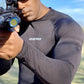 Person in Maxx-Dri Silver Elite Long Sleeve Shirt holding a rifle outdoors