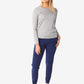 Person in grey women’s long-sleeve underscrub paired with navy joggers and white sneakers