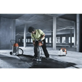 Person using a jackhammer with Husqvarna 540i battery powered core drill kit