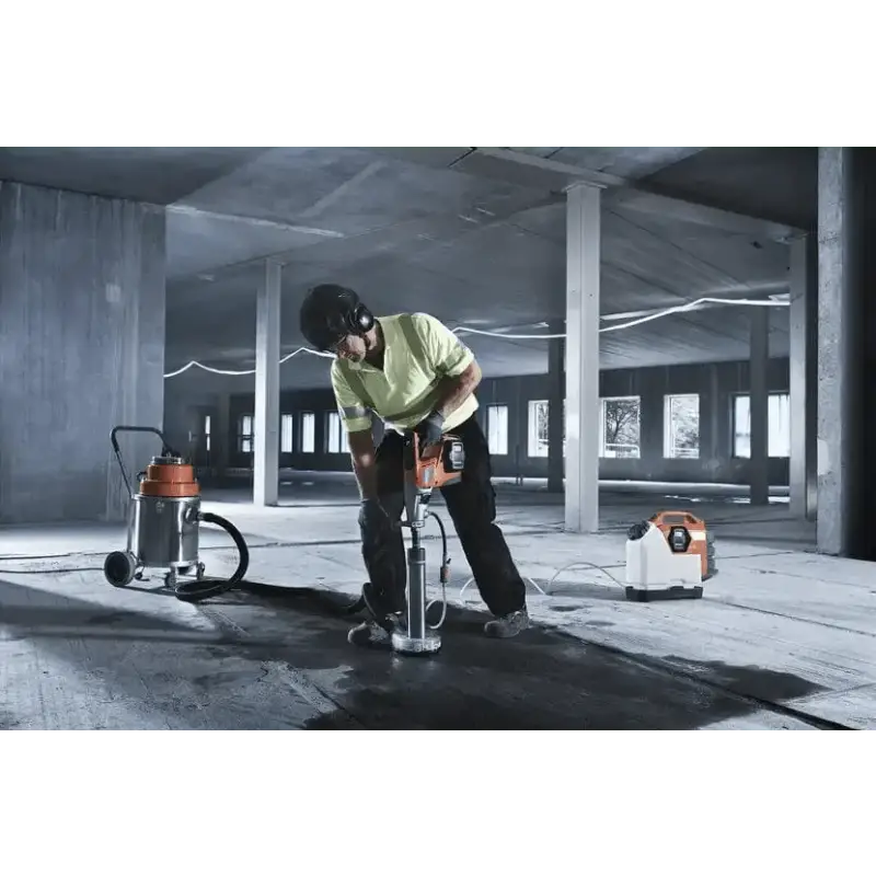 Person using a jackhammer with Husqvarna 540i battery powered core drill kit