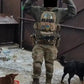 Person in full body armor tactical gear with two dogs and food bowls for large size protection