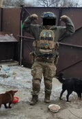 Person in full body armor tactical gear with two dogs and food bowls for large size protection