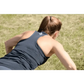 Person in navy blue tank top lying on grass wearing Women’s Performance Racerback Tank