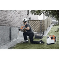 Person using Husqvarna 540i battery powered core drill kit next to a brick wall