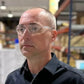 Person in safety glasses with flexible temples from METEL M20, featuring a wraparound lens