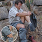 Person removing a snake from Zambezi Convertible Zip Off Safari Pants on rocky terrain