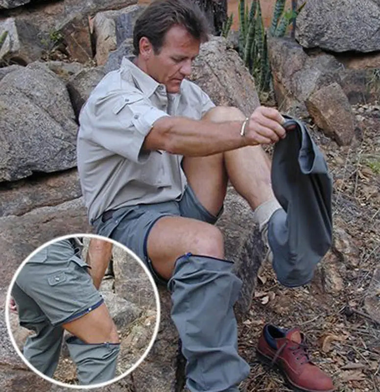 Person removing a snake from Zambezi Convertible Zip Off Safari Pants on rocky terrain