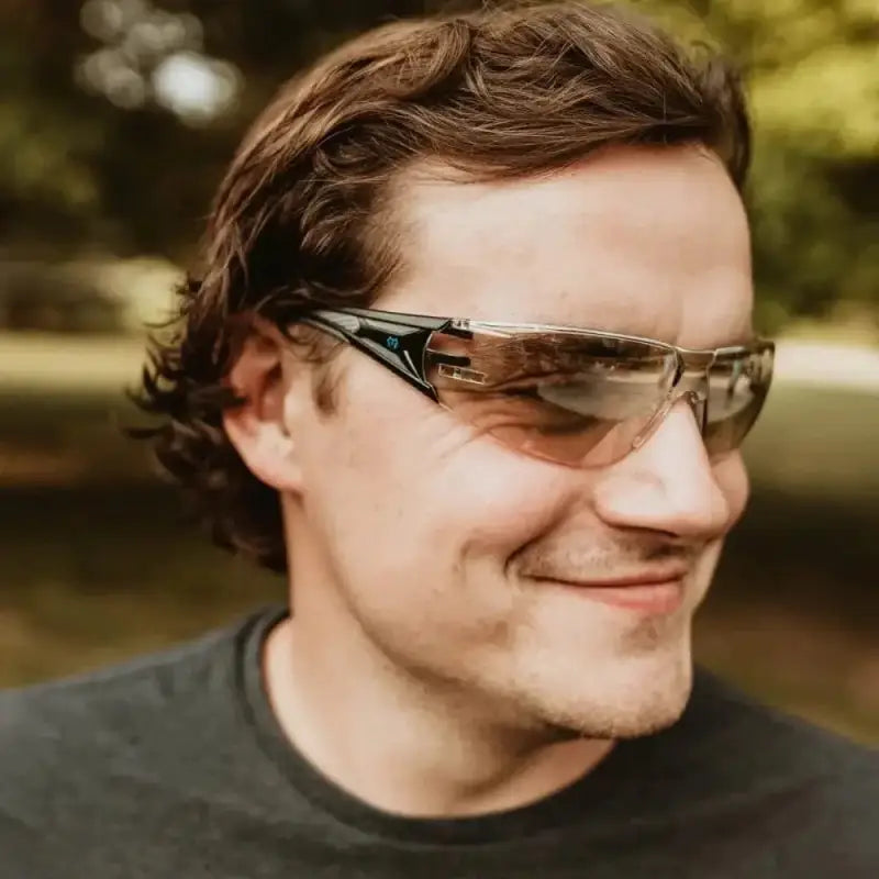 Person wearing METEL M50 Safety Glasses, sporty gradient lenses, and a dark shirt