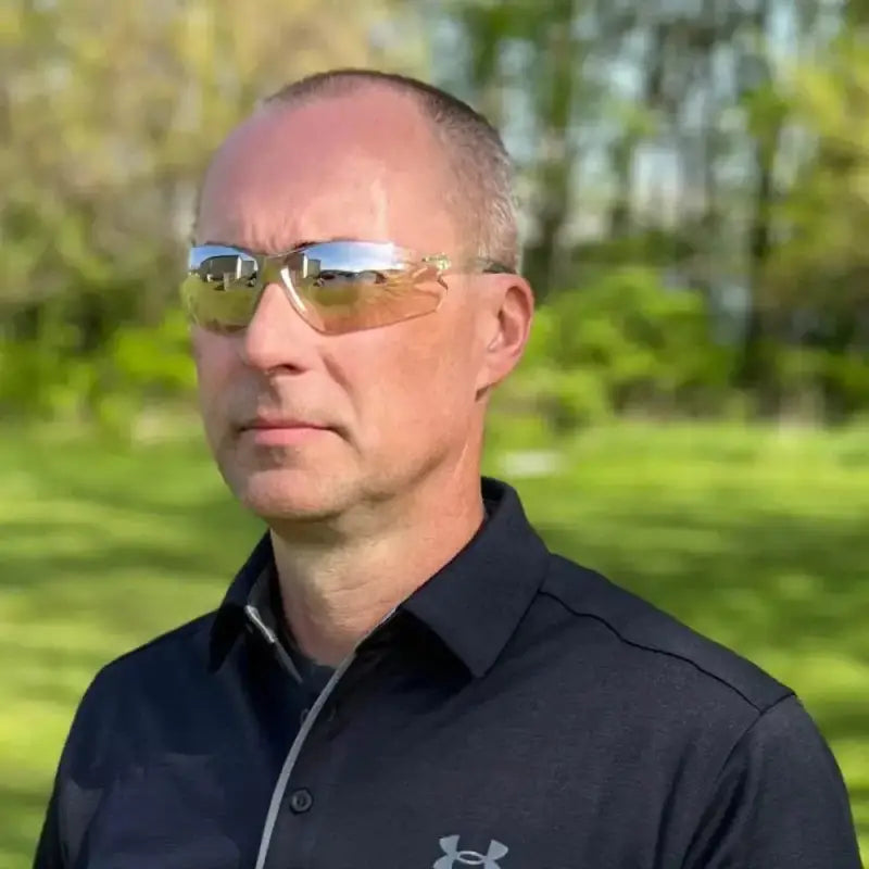 Person in sunglasses and black Under Armour polo showcasing Metel M20 Safety Glasses