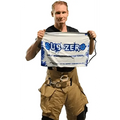 Person in tan cargo pants holding Subzero Cooling Towel with H2O Heat Barrier