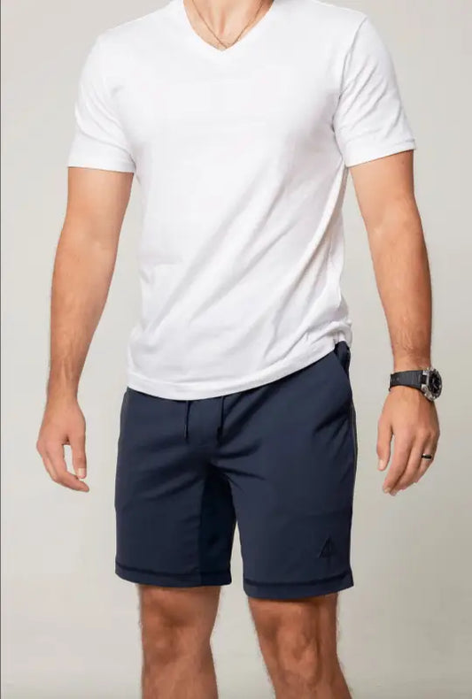 Person in a white v-neck t-shirt and navy shorts from Arrowhead Tactical Apparel