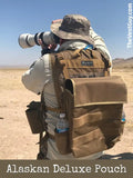 Photographer in tactical gear using a long lens with Black Mesh CSI Vest in desert