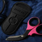 Pink and black trauma shears with black titanium coated blades and protective sheath