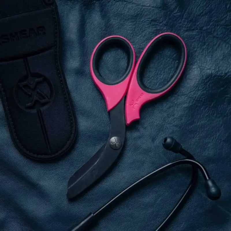 Pink trauma shears with black titanium coated stainless blades for emergency providers