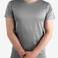 Plain gray crew neck t-shirt worn as a men’s short-sleeve underscrub with clasped hands