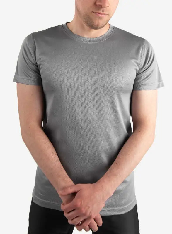 Plain gray crew neck t-shirt worn as a men’s short-sleeve underscrub with clasped hands