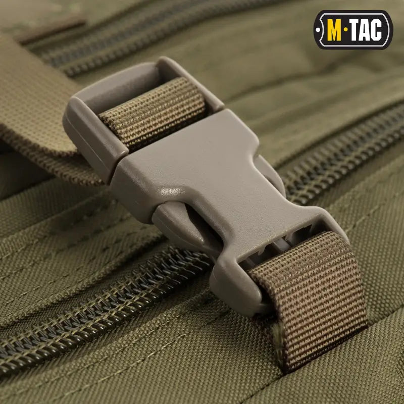 Plastic buckle clip with olive nylon webbing on M-Tac Assault Pack with large zippered compartments