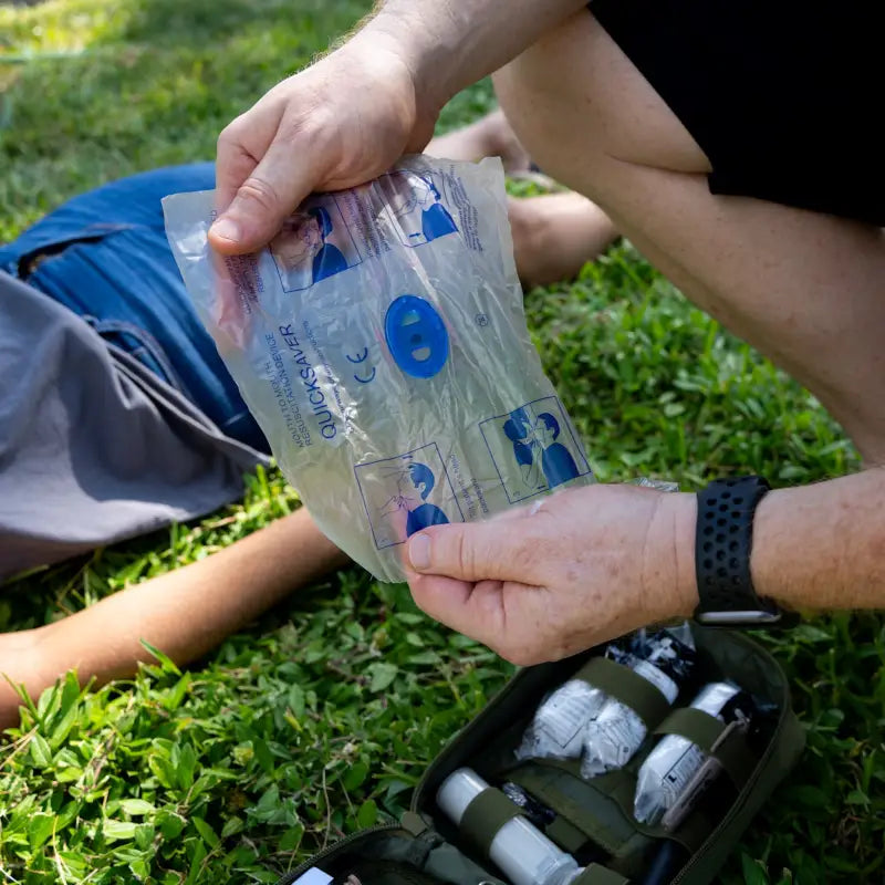 Plastic hydration pack held in hands, featured in the Responder IFAK Kit