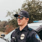 Police officer in black uniform and sunglasses promoting NADO Ghost for first responders