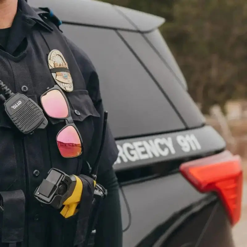 Police officer uniform with NADO Sunset gear for first responders, featuring badge and radio