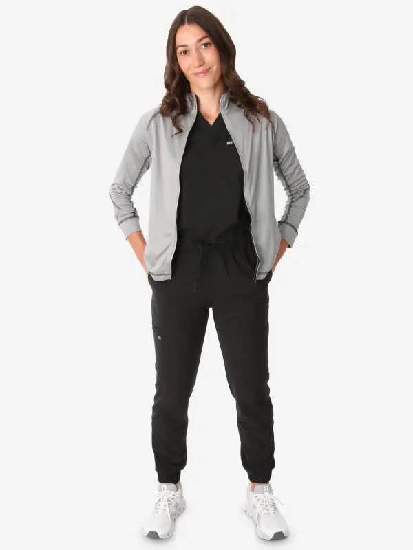 Professional athletic wear with a black jumpsuit and light grey women’s scrub jacket