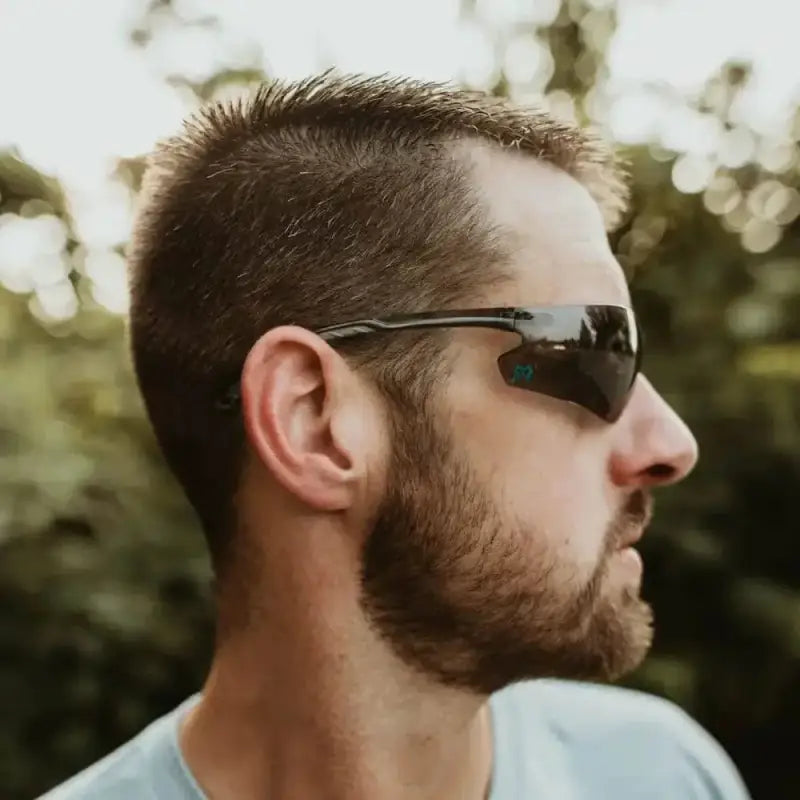 Side profile of a man in dark sunglasses showcasing METEL M20 Safety Glasses with flexible temples