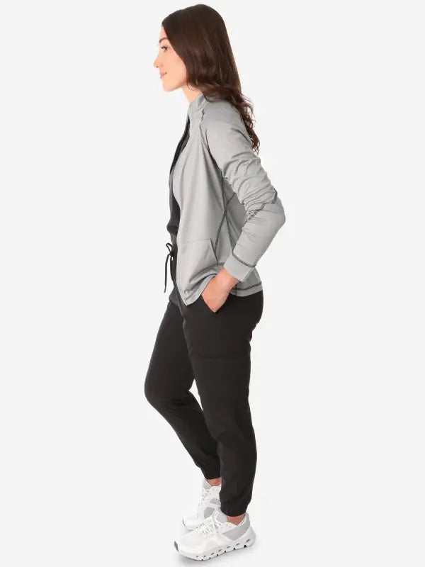 Side profile of a woman in a gray blazer and pants showcasing a women’s scrub jacket