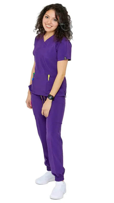 Purple Women’s 4-Way Extreme Stretch Jogger Scrubs with white shoes for comfort and style