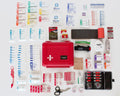 Red first aid kit with rolled gauze and Cool Blaze Burn supplies around it